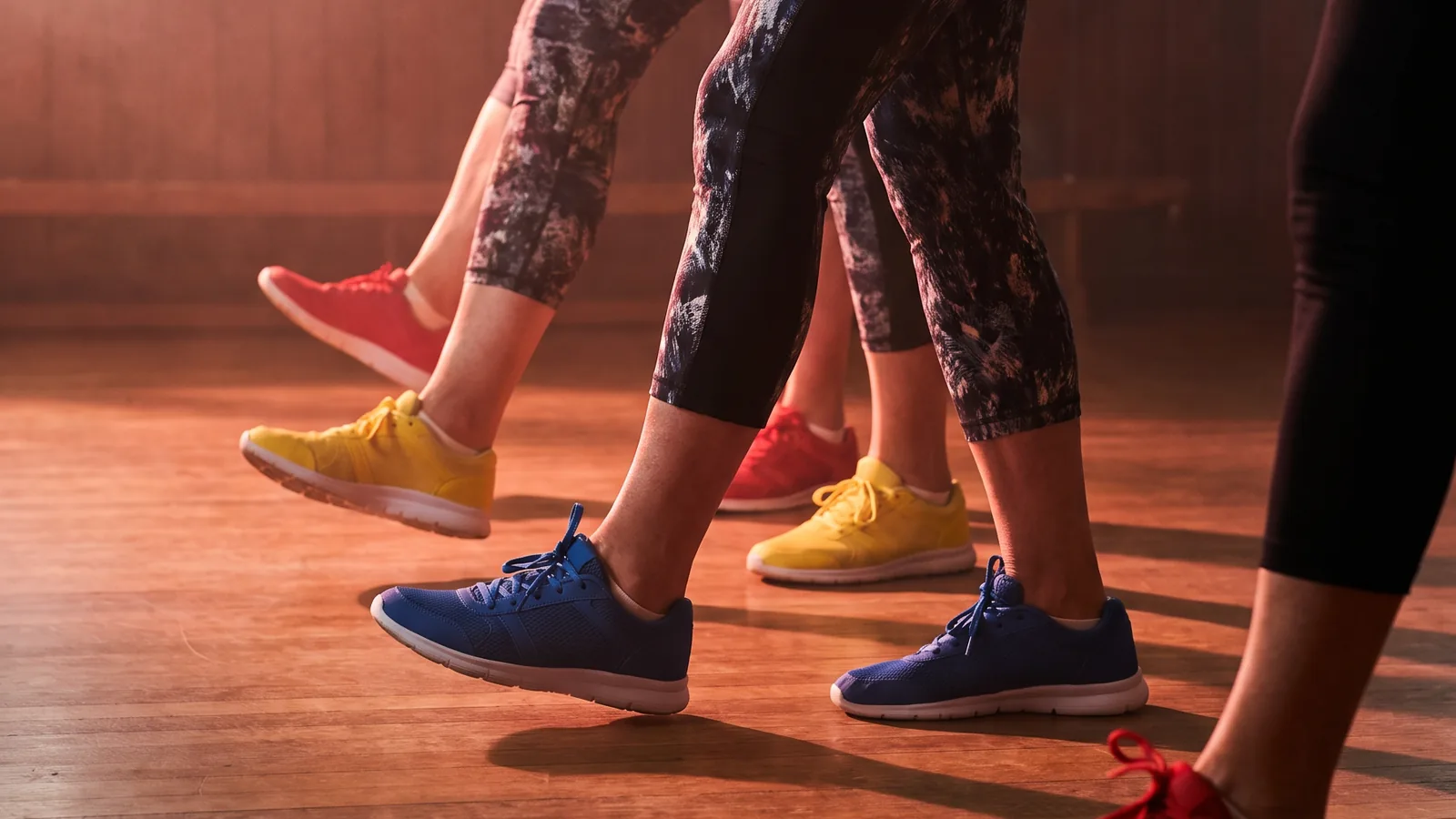 Seniorzy na zajęciach dance fitness, zbliżenie na nogi i hantle